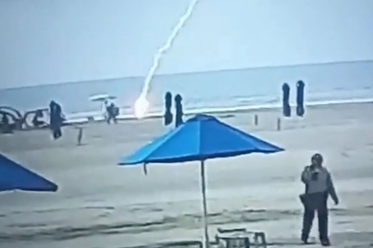 Click to enlarge CCTV security video footage of the moment shows bikini-clad Froilanis suddenly hit by lightning