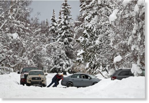 Click to enlarge People help push a car after the car got stuck in