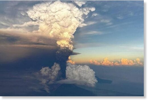 Click to enlarge Ash column rises from Mount Ulawun, as seen from an aeroplane window, Papua New Guinea November 21, 2023, in this picture obtained from social media.