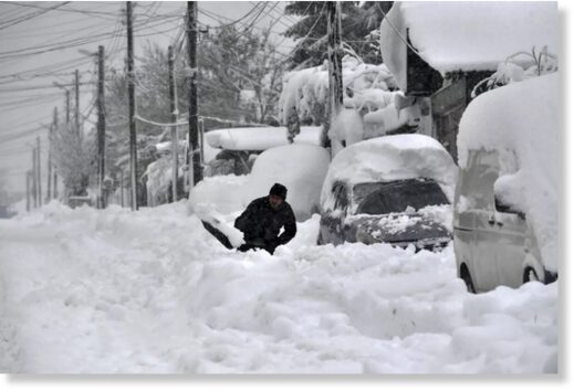 Click to enlarge A man shovels snow, as he tries to clear his car in town of Isperih, Northeast Bulgaria, Sunday, Nov. 26, 2023.