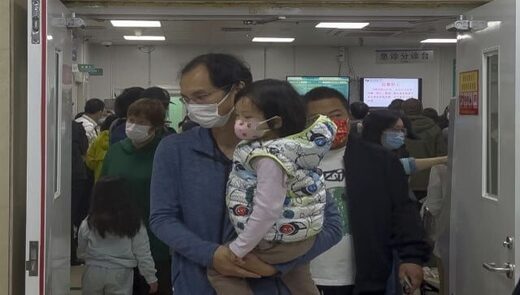 Click to enlarge man carries child hospital