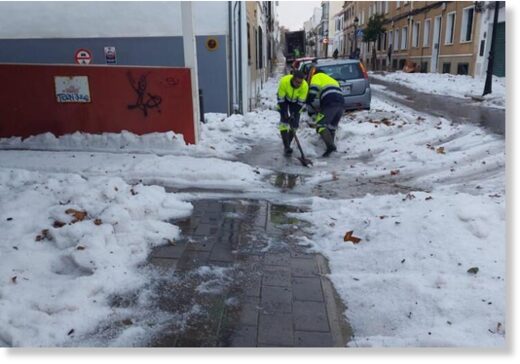 Municipal workers in Mahon clearing away the hail.