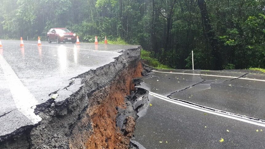 Click to enlarge This photo from Transport and Main Roads Queensland shows severe damage to the Palmerston Highway after flooding caused by ex-Tropical Cyclone Jasper.