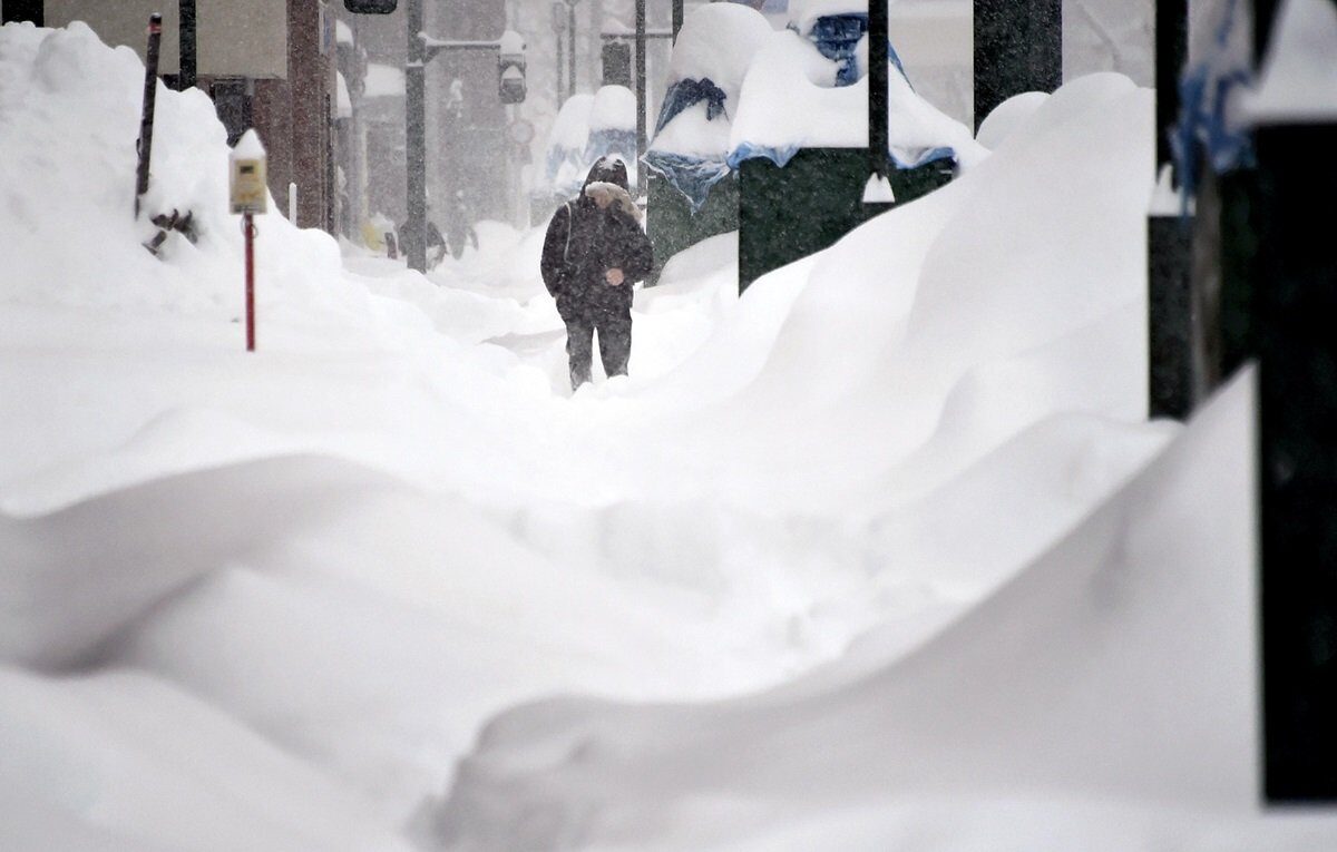 A person walks through snow on Friday morning in Iwamizawa, Hokkaido.