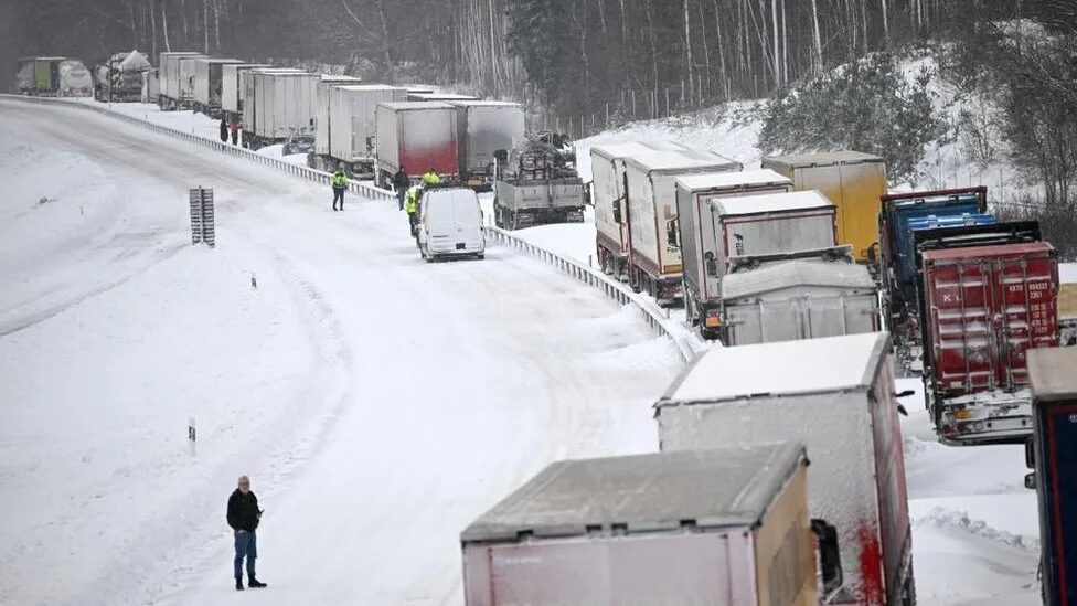Click to enlarge Rescue teams began clearing cars from the snowbound E22 but many of the lorries were expected to remain on the road until Friday