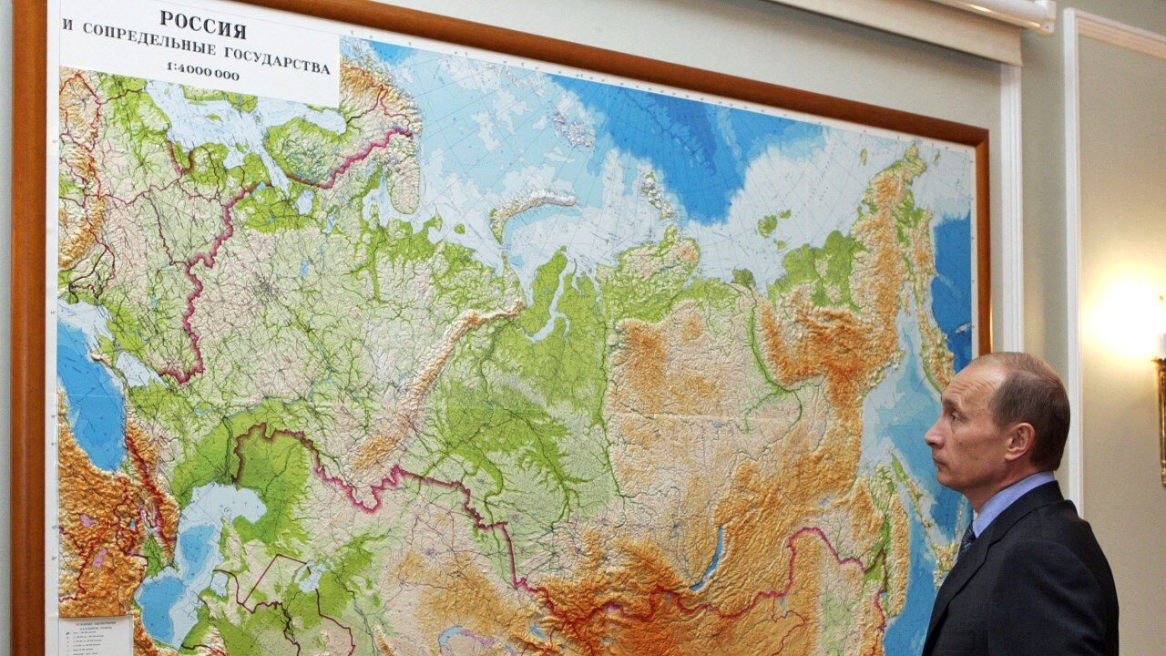 Putin Looking at Russia Geography