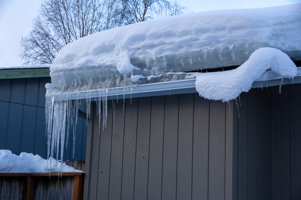 An ice dam forms on the roof of an Airport Heights home in Anchorage in 2023.