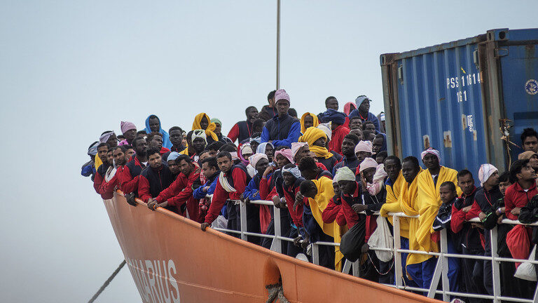 Click to enlarge African migrants landing in the port of Salerno aboard the
