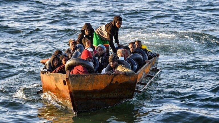 Migrants sit in a makeshift boat