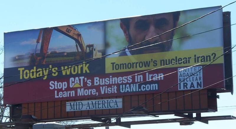 Click to enlarge A billboard erected by United Against Nuclear Iran near Caterpillar’s Illinois headquarters.