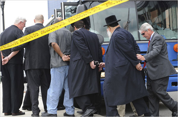 Agents led suspects from F.B.I. headquarters in Newark on Thursday. The inquiry began with questions on money laundering.