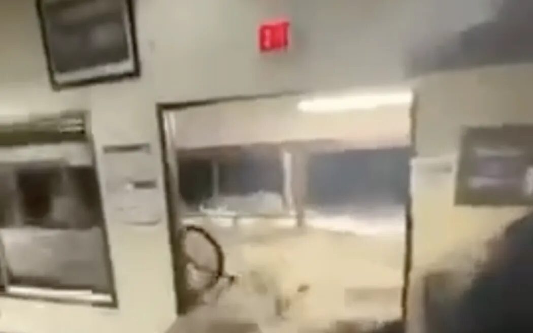 Screenshots of wave hitting Roi-Namur dining room. The waves smashed down the dining hall's doors, knocking people down and flooding the facility as this screenshot from a video