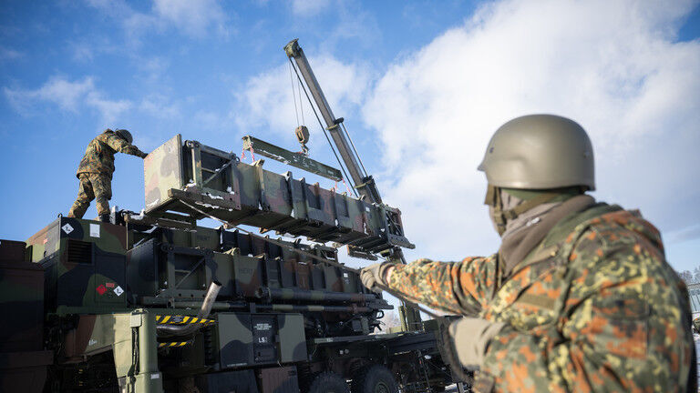 Ukrainian soldiers reload a Patriot air defense system