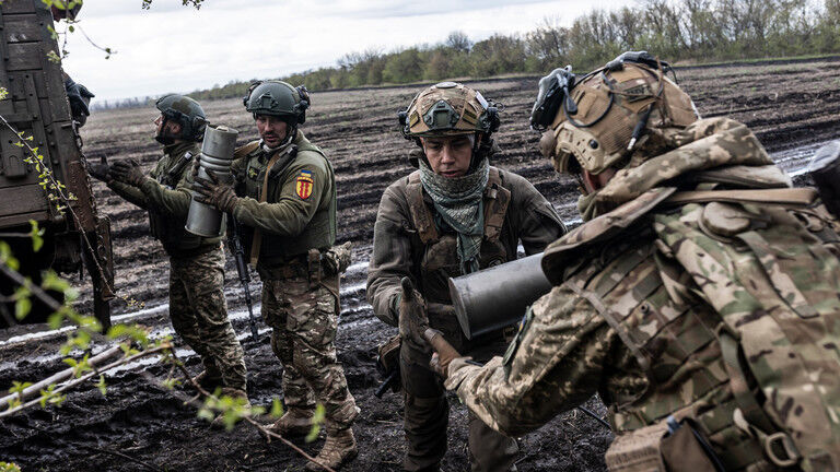 Ukrainian soldiers unload ammunition from a military truck.