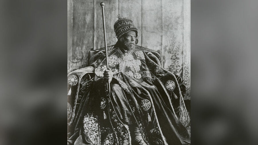 Click to enlarge Emperor Menelik II photographed on the throne in coronation garb.
