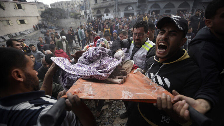 Click to enlarge Palestinians carry a dead girl, found under the rubble of a destroyed building in Khan Younis, Gaza, December 7, 2023