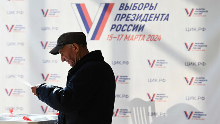 FILE PHOTO: A man votes at a polling station during the presidential election in Moscow, Russia.