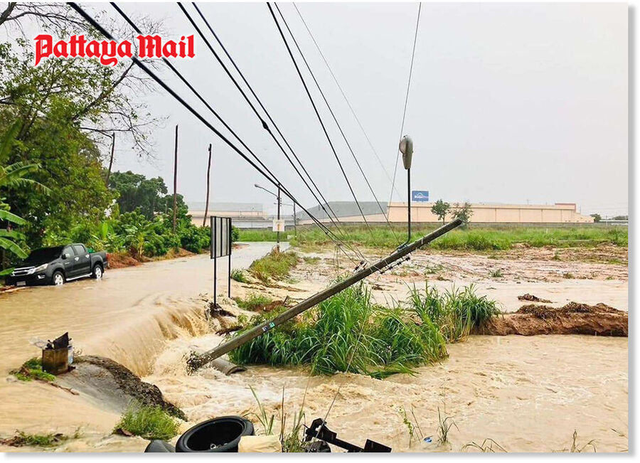 Vehicles struggle to navigate through flooded Highway 331 Mab Eiang-Laem Chabang Road near Pintong 1-2 Industrial Estates, showcasing the hazardous driving conditions caused by relentless downpours and runoff in Sri Racha.