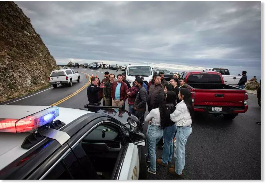 California Highway Patrol officer John Yerace directs traffic and informs travelers and residents about the road closure on Highway 1, site of a slide.