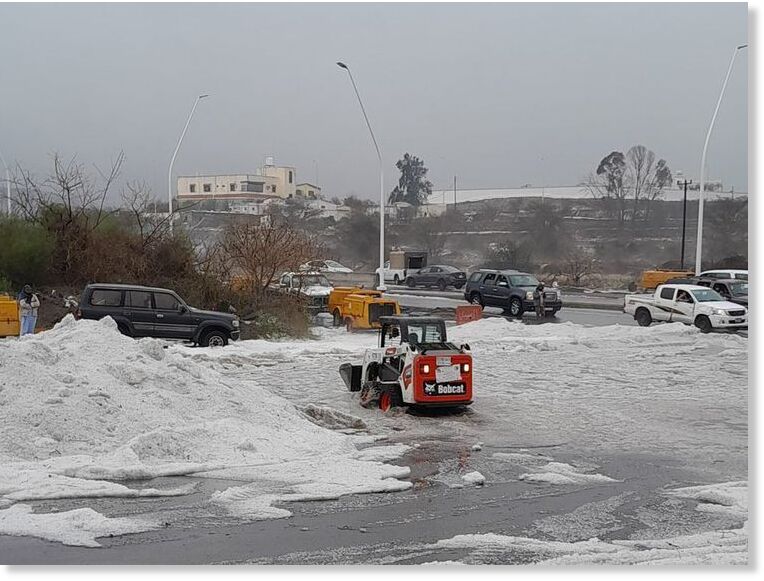 Municipal workers and field teams clearing the hail from major roads and streets to facilitate the resumption of normal traffic flow.