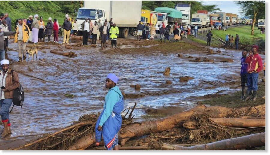 People gather on the main road after a dam burst in Kamuchiri Village Mai Mahiu, Nakuru County, Kenya on April 29, 2024.