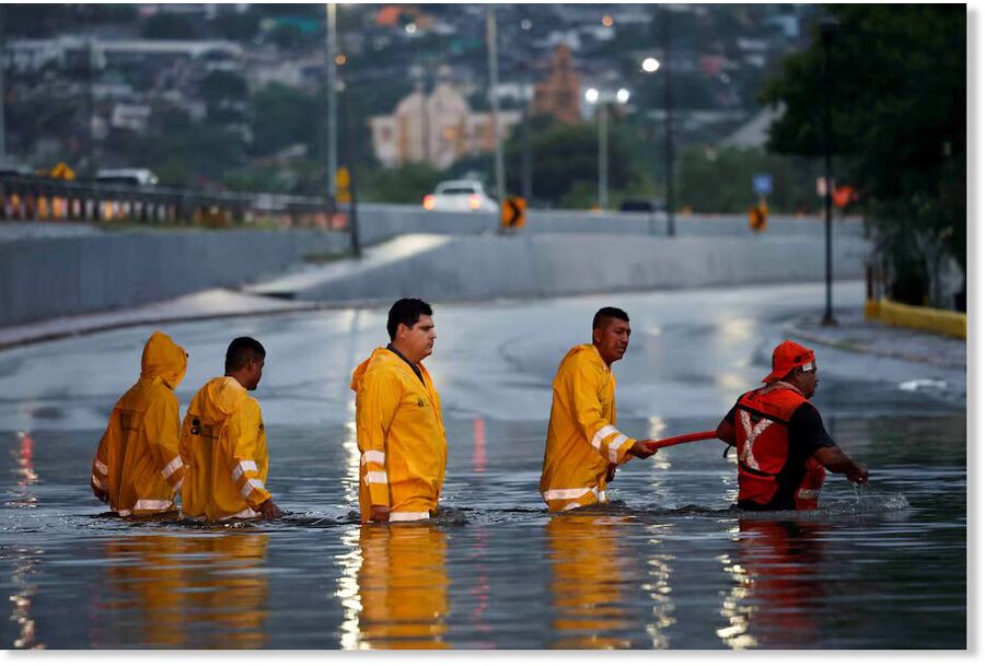 Government employees work to drain a flooded overpass as Tropical Storm Alberto brings heavy rain to Monterrey, Mexico, on June 19.