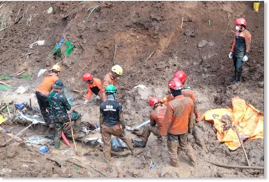 Click to enlarge Rescue workers search for victims