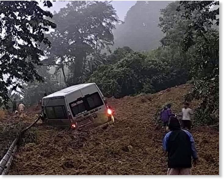 Click to enlarge A 16-seater van is buried in a landslide in Bac Me District of Ha Giang, July 13, 2024.