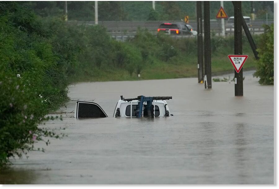 A car is partially submerged in flood waters by heavy rain in Paju, South Korea.