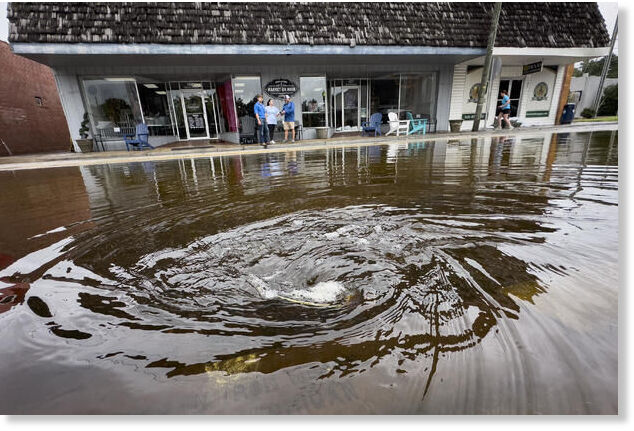 Click to enlarge A drain pulls in residual rain water floods