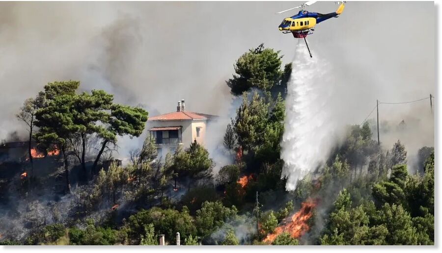 A wildfire threatens homes near Athens on 11 August