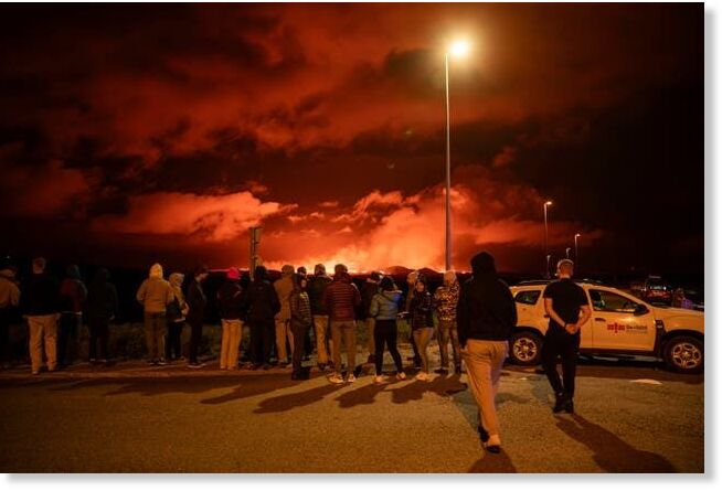 Tourists and visitors try to get a view of the eruption from a distance from the intersection between Reykjanesbraut, Iceland, and the road to Grindavik, Thursday, 22 August 2024 (