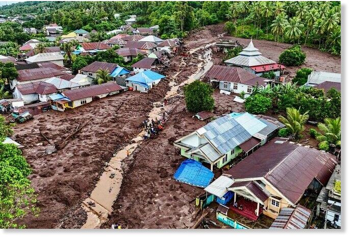 Click to enlarge This aerial view shows rescue teams and residents searching for victims buried in mud after a flashflood hit the village of Rua located at the foot of Mount Gamalama, in Ternate, North Maluku.