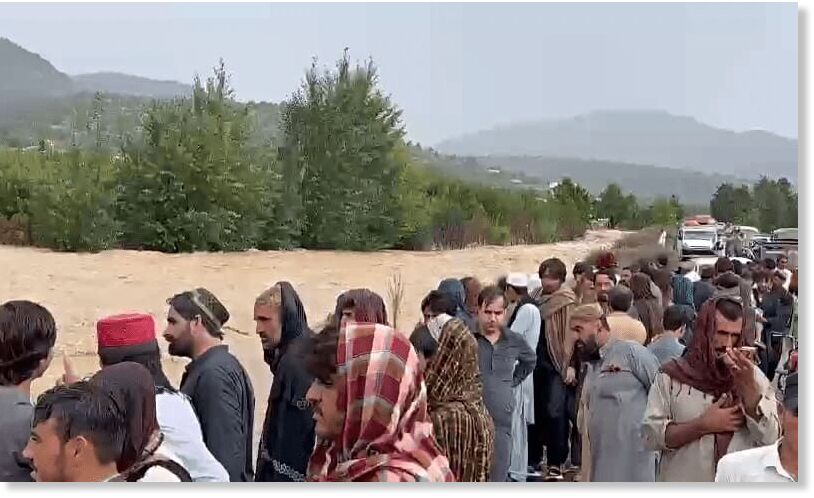 People gather near flashfloods in Balochistan on Sept 2.