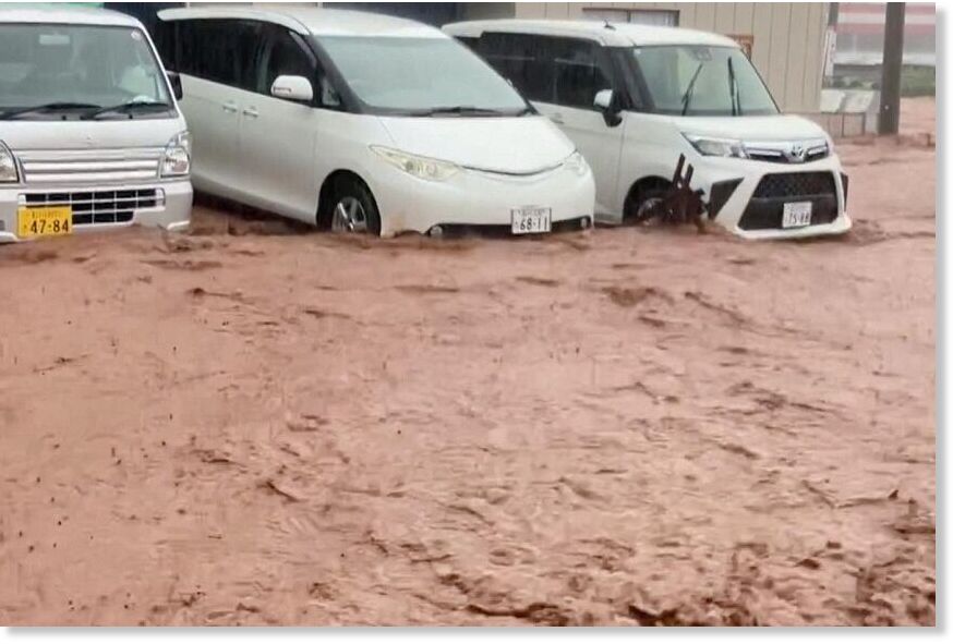 Vehicles partially submerged in flood waters amid heavy rain in Wajima, Ishikawa prefecture, on Sept 21.