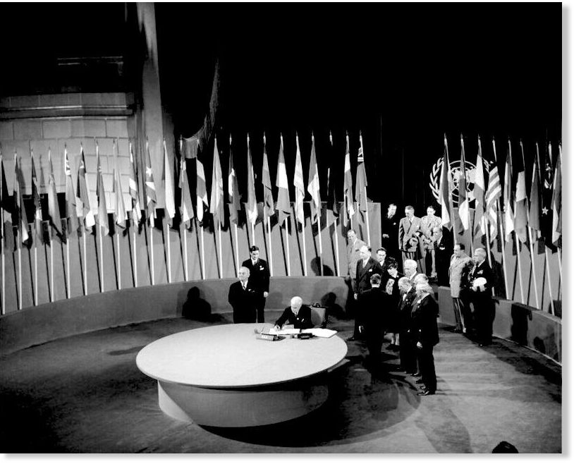 Click to enlarge signing the U.N. Charter at a ceremony