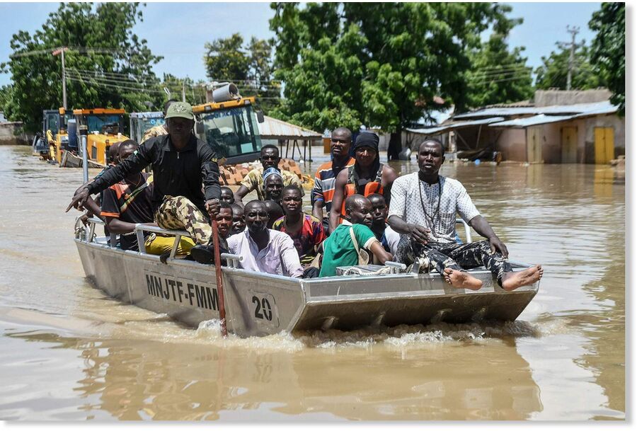 Click to enlarge People affected by floods are escorted through flood water on a military boat in Maiduguri, Nigeria, September 12, 2024.