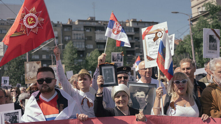 People carry portraits of World War II soldiers during the 'Immortal Regiment' march on May 9, 2022 in Belgrade, Serbia.