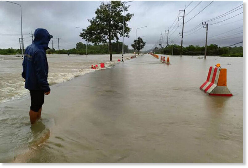 Click to enlarge A man looks at the flooded Road 43 in Nong Chik