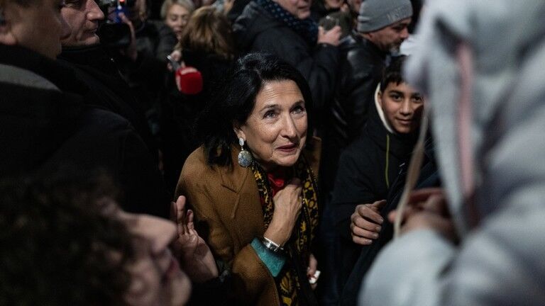 Click to enlarge Georgian President Salome Zourabichvili walks in the crowd of anti-government protesters.