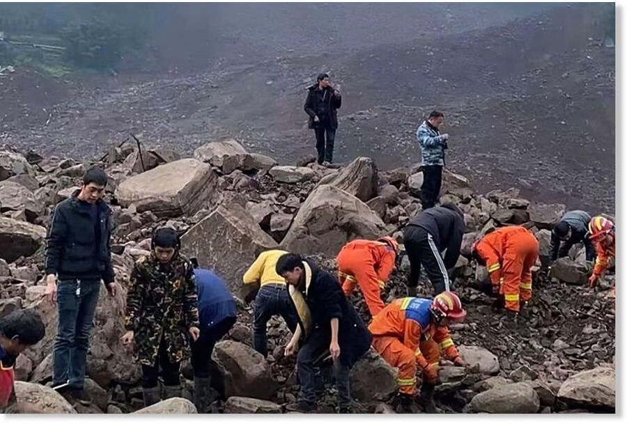Emergency workers search the site of a landslide in Jinping, Sichuan province, on Saturday.