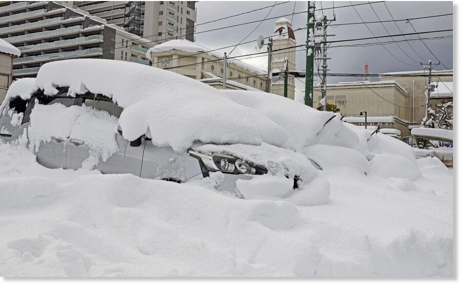 A car is covered by snow in Niigata City on Saturday.