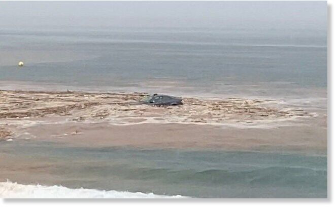 Click to enlarge The Atlantic Ocean appears to have claimed several cars after flood waters washed them away