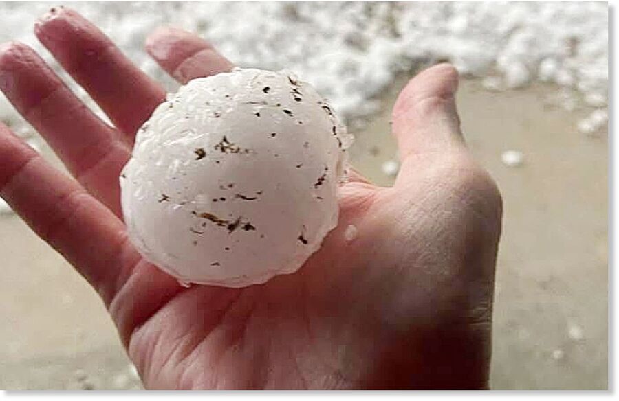 Kim Meismer of Kerrville holds a large ball of hail from a storm on Sunday.