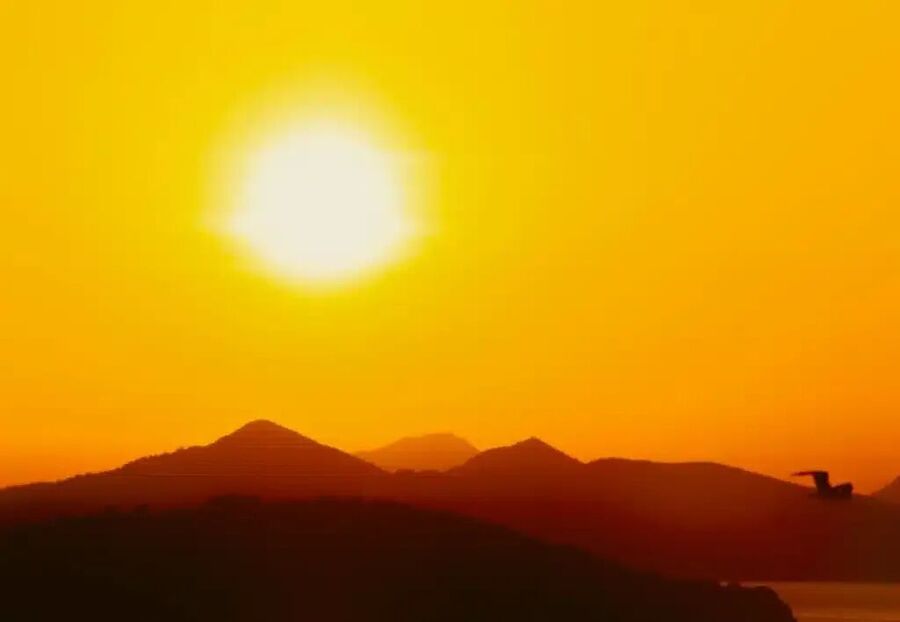 Click to enlarge The Sun over mountains