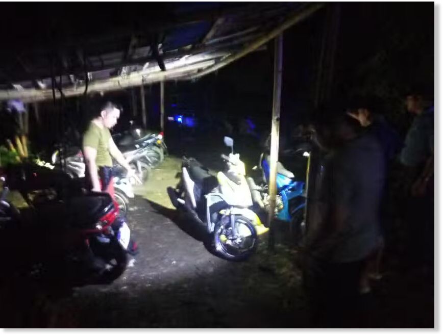 Click to enlarge Police inspect the area where two officers were killed in a lightning strike after the cops parked their motorcycles at the Mimaropa Regional Mobile Force Battalion headquarters in Naujan, Oriental Mindoro, on Wednesday evening, May 14, 2025