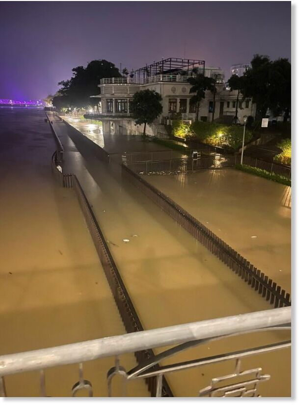Click to enlarge A pedestrian bridge along the Huong River is flooded.