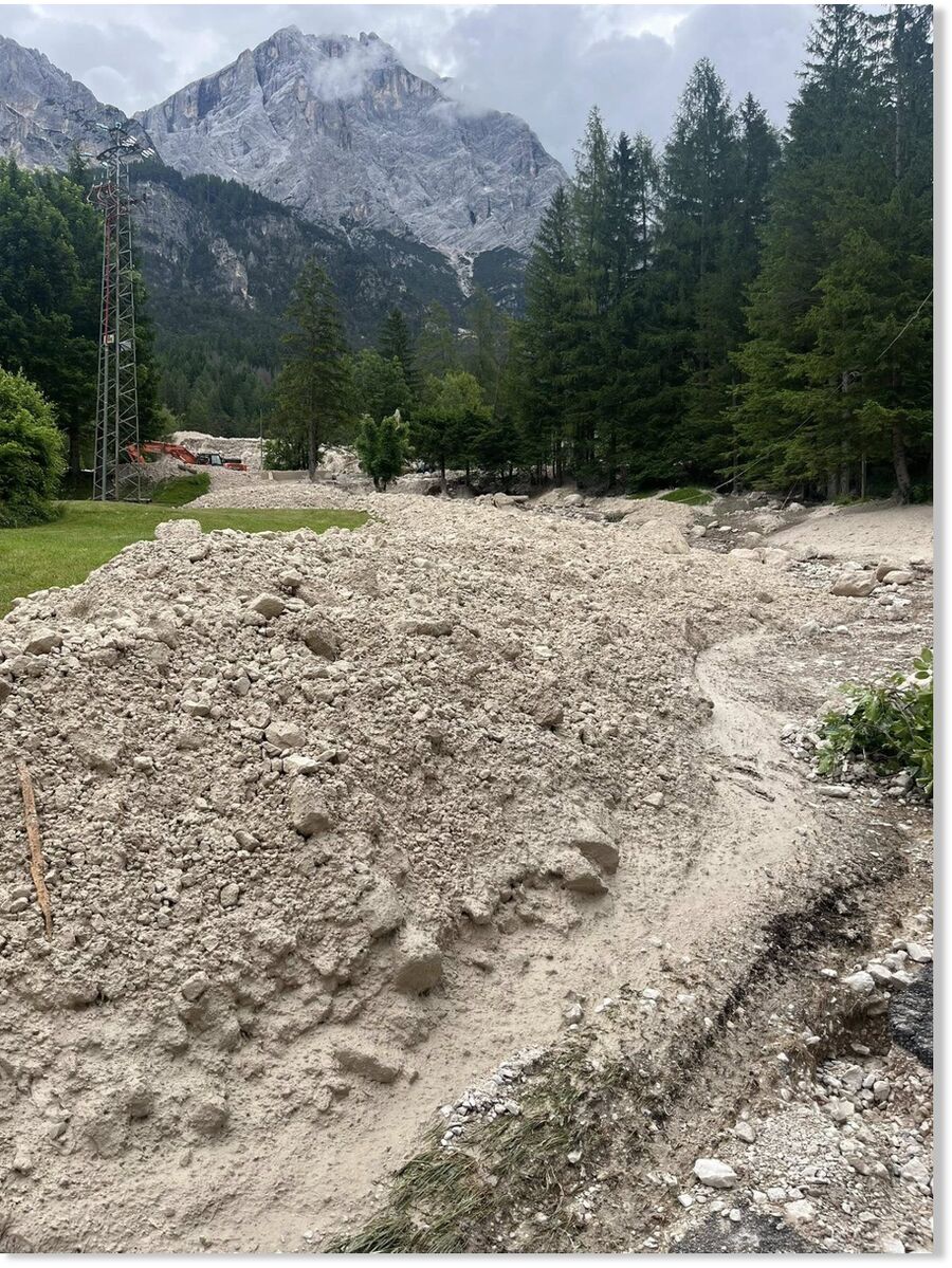 Click to enlarge Tons of rock and debris spilled down the mountain and trapped 10 people inside their homes.