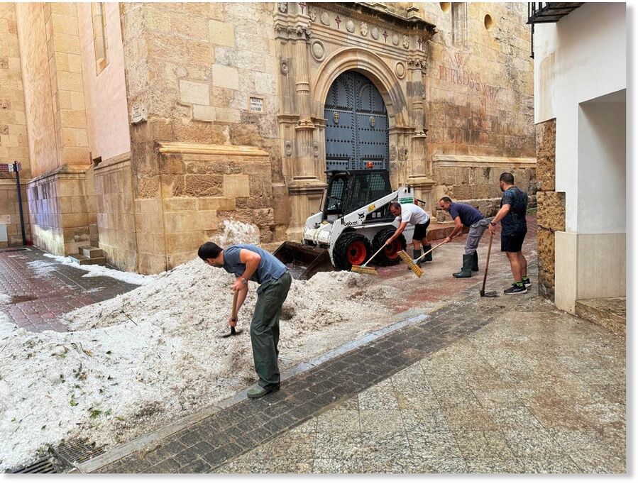 Thick layers of hail piled up on pavements and roads in the town