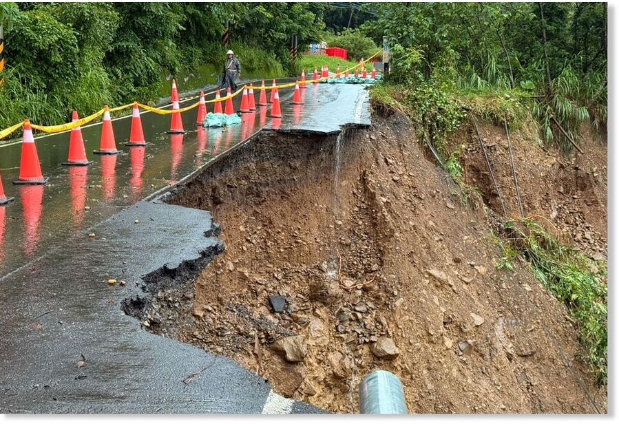 This handout photo released by the Kaohsiung Fire Department shows a landslide that swept away a section of road, sending a car carrying five people plunging into a ravine in a mountainous part of Kaohsiung.